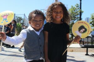 Little boy and girl smiling and holding clean air signs